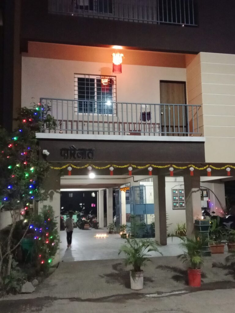 Front view of Parijat PG building with parking and entrance in Hadapsar Pune